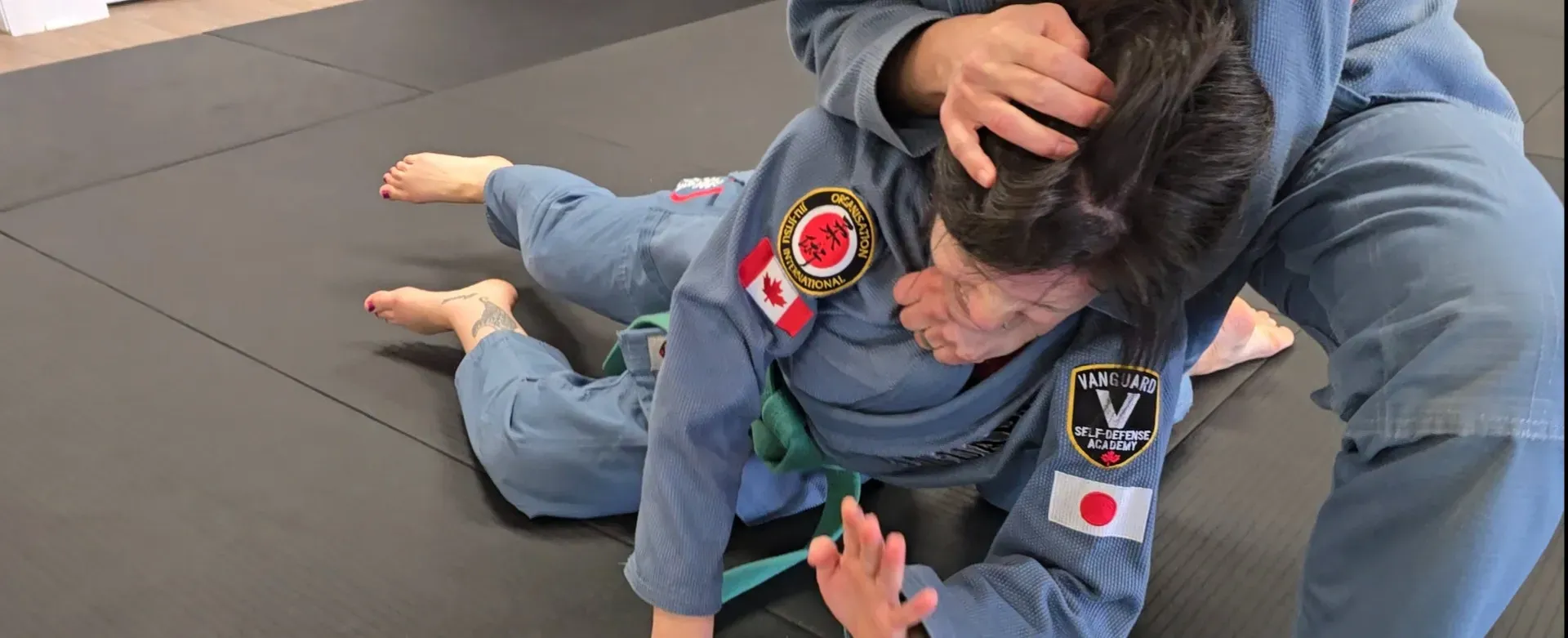 Adult students practising a controlled partner drill at Vanguard Self-Defense Academy